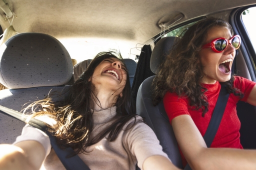 Zwei junge Frauen, die in einem Auto unterwegs sind